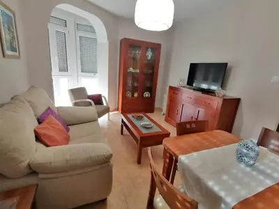 a living room with a couch and a table at Keka en Playa la Victoria con Ascensor Grupo AC Gestion in Cádiz