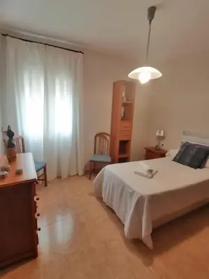 a bedroom with a bed and a desk and a window at Keka en Playa la Victoria con Ascensor Grupo AC Gestion in Cádiz