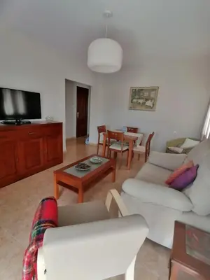 a living room with a couch and a table at Keka en Playa la Victoria con Ascensor Grupo AC Gestion in Cádiz