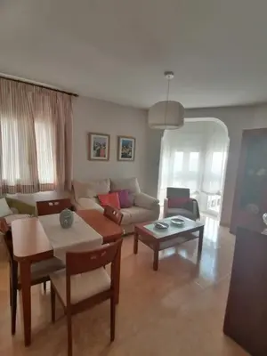 a living room with a couch and a table at Keka en Playa la Victoria con Ascensor Grupo AC Gestion in Cádiz