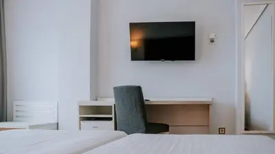 a bedroom with a desk and a chair and a tv at Hotel Bahia Sur in San Fernando