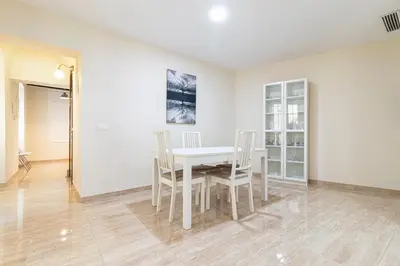 a white dining room with a white table and chairs at Allo Apartments Consistorio Centro 2 Habitaciones in Jerez de la Frontera