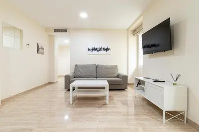 a living room with a couch and a table at Allo Apartments Consistorio Centro 2 Habitaciones in Jerez de la Frontera