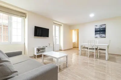 a living room with a couch and a table at Allo Apartments Consistorio Centro 2 Habitaciones in Jerez de la Frontera