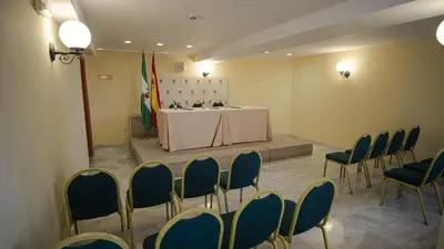 a room with a table and chairs in a room at Crisol Chiclana in Chiclana de la Frontera