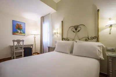 a bedroom with a large white bed with white pillows at Crisol Chiclana in Chiclana de la Frontera