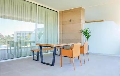 a dining room with a table and chairs at Gorgeous Apartment In Chipiona in Chipiona