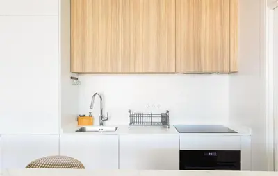 a kitchen with white cabinets and a sink at Gorgeous Apartment In Chipiona in Chipiona
