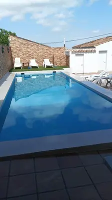 a patio with two trees and a swing at El Recuerdo in Arcos de la Frontera