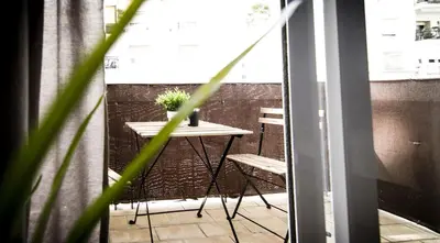 a small table and chairs on a balcony at Apartamento San Juan in El Puerto de Santa María