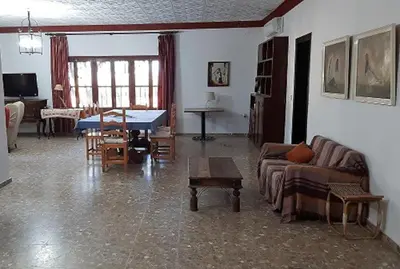 a living room with a couch and a table at Finca La Parrilla Maison Piscine nature chevaux in Arcos de la Frontera