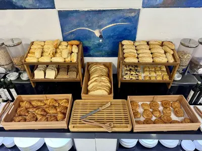 a display of different types of bread and pastries at Hotel Guadalquivir in Sanlúcar de Barrameda