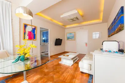 a living room with a glass table at Hotel Guadalquivir in Sanlúcar de Barrameda