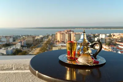 a table with two cups and a tea pot on it at Hotel Guadalquivir in Sanlúcar de Barrameda