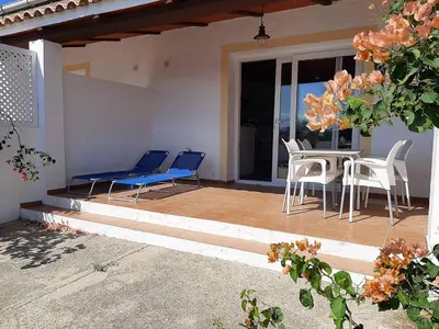 a patio with chairs and a table and a table and chairs at Studio andalou , campagne , chevaux , piscine commune in Arcos de la Frontera