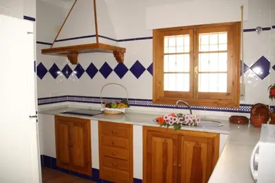 a kitchen with a sink and a counter top at Penthouse Sleeps 4 with Private Garden in Chipiona