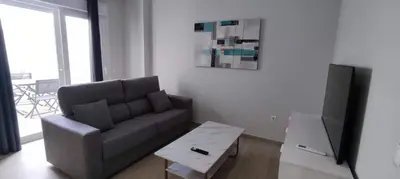 a living room with a couch and a tv at Guesting Hospital in Cádiz