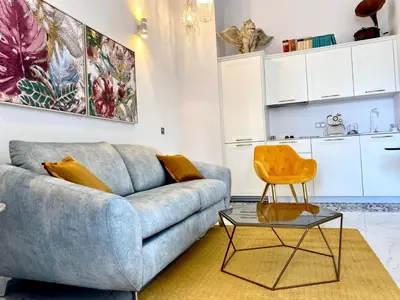 a living room with a blue couch and a table at innCádizCasa Señorial Rivadavia in Cádiz
