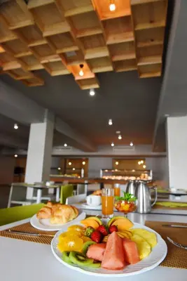 two plates of fruit on a table in a restaurant at Hotel Agaró in Chipiona