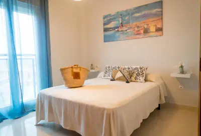 a bedroom with a bed with a white blanket at R&B Vistahermosa Views in El Puerto de Santa María