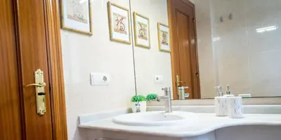 a bathroom with a sink and a mirror at R&B Vistahermosa Views in El Puerto de Santa María