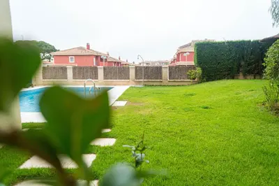a yard with a swimming pool and green grass at R&B Vistahermosa Views in El Puerto de Santa María