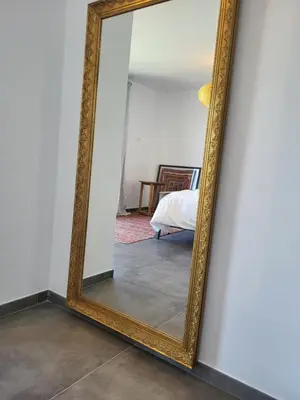 a mirror hanging on a wall in a room at Family house with nice garden 10min from Sanlúcar in Sanlúcar de Barrameda