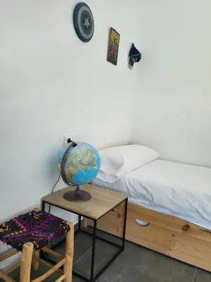 a bedroom with a bed and a table with a globe at Family house with nice garden 10min from Sanlúcar in Sanlúcar de Barrameda