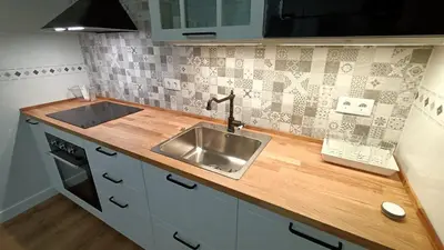 a kitchen with a sink and a wooden counter top at Apartamento Victoria in Cádiz