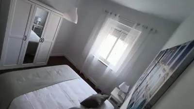 a small bedroom with a bed and a window at Apartamento Victoria in Cádiz