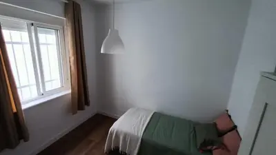 a bedroom with a bed and a window at Apartamento Victoria in Cádiz