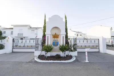 a white fence in front of a white house at Duplex Near the Beach in Chiclana de la Frontera