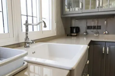 a kitchen with a white sink and a window at Beautiful Duplex in Chiclana de la Frontera