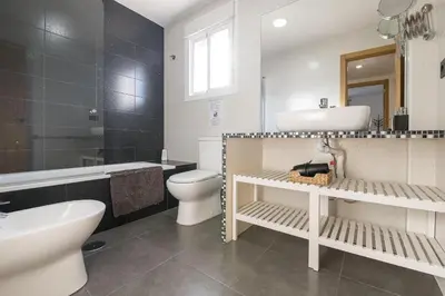a bathroom with a sink and a toilet and a tub at Beautiful Duplex in Chiclana de la Frontera