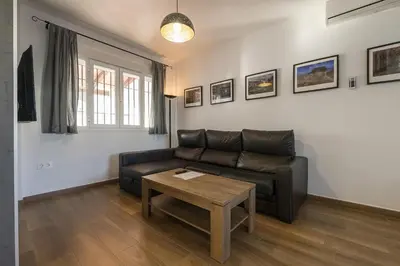 a living room with a leather couch and a table at Beautiful Duplex in Chiclana de la Frontera
