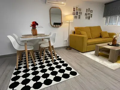 a living room with a table and a couch at Aromas de Bodega in Jerez de la Frontera