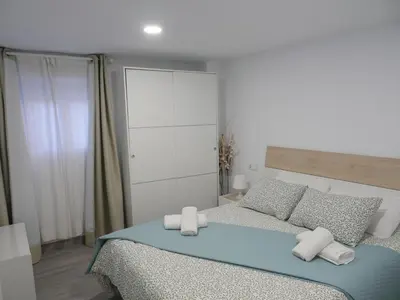 a bedroom with a bed with two white pillows at Aromas de Bodega in Jerez de la Frontera