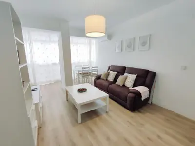a living room with a couch and a table at Alonso Cano Playa in Cádiz