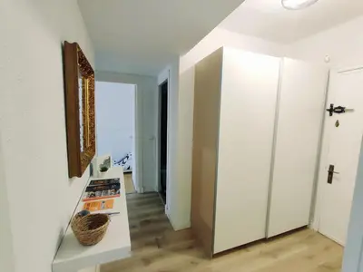 a room with a hallway with white walls and a mirror at Alonso Cano Playa in Cádiz