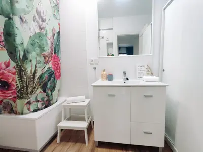 a bathroom with a sink and a shower curtain at Alonso Cano Playa in Cádiz