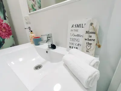 a bathroom with a white sink and a mirror at Alonso Cano Playa in Cádiz