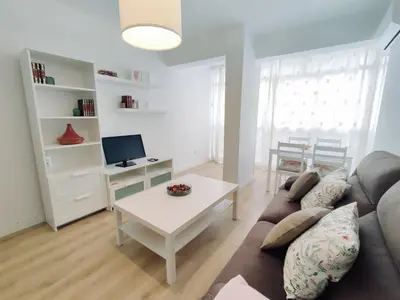 a living room with a couch and a table at Alonso Cano Playa in Cádiz
