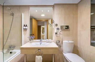 a bathroom with a sink and a toilet and a tub at Hotel Jerez Centro in Jerez de la Frontera
