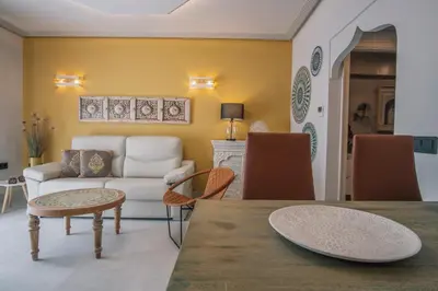 a living room with a table and a couch at Apartamentos Turísticos La Baílla in Rota