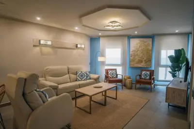 a living room with a couch and a table at Apartamentos Turísticos La Baílla in Rota