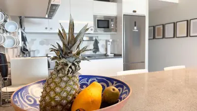 a bowl of fruit on a table in a kitchen at Arenas de Sanlúcar in Sanlúcar de Barrameda