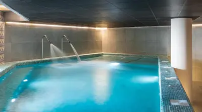 a large swimming pool with blue water in a room at ALEGRIA Costa Ballena Aquafun in Costa Ballena