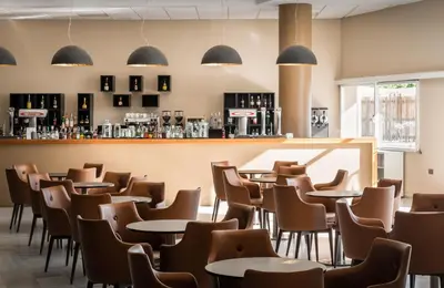 a restaurant with tables and chairs and a bar at ALEGRIA Costa Ballena Aquafun in Costa Ballena
