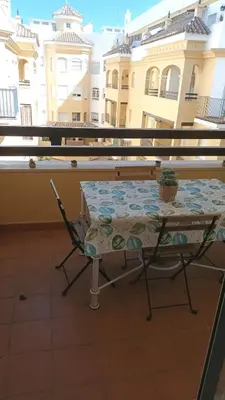 a table and chairs sitting on a balcony at Apto MANAMAR - Entre centro y playa - Parking privado gratis in Sanlúcar de Barrameda