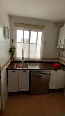 a kitchen with a sink and a window at Apto MANAMAR - Entre centro y playa - Parking privado gratis in Sanlúcar de Barrameda